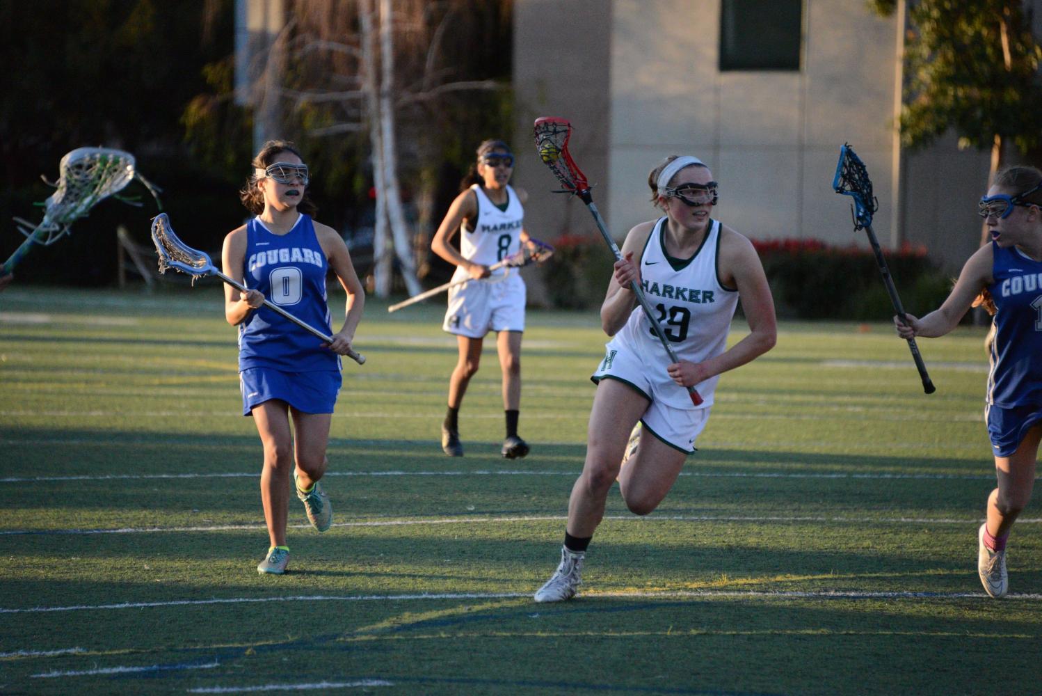 Alayna Richmond runs with the lacrosse ball. The lacrosse team currently holds a league record of 1-3.