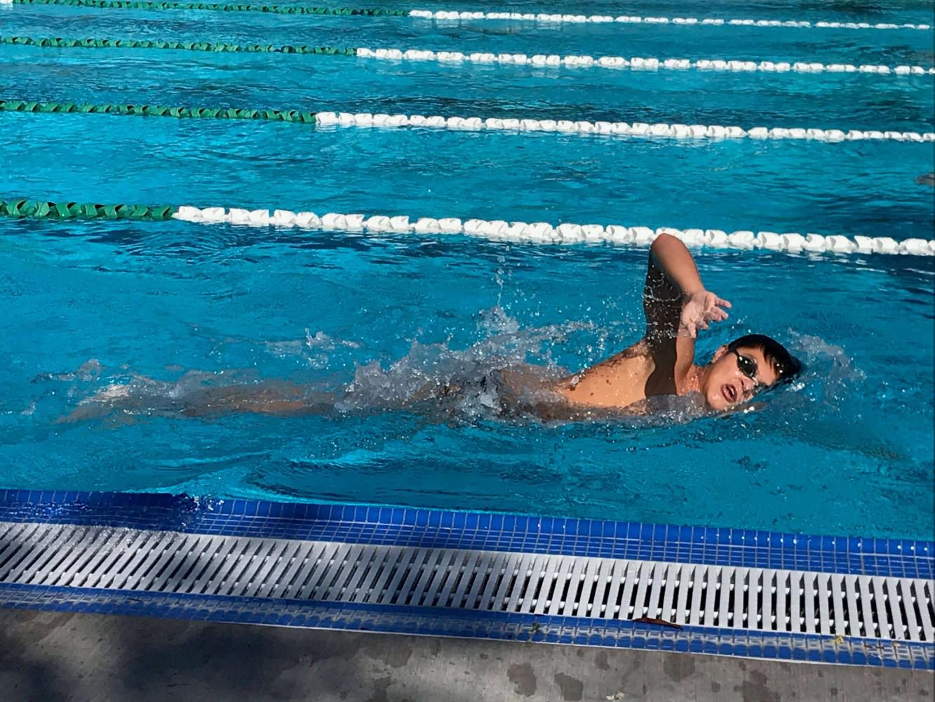 Senior+Michael+Auld+swims+freestyle+during+practice.+Michael+swam+on+the+400+freestyle+relay+that+broke+the+school+record+this+past+weekend.
