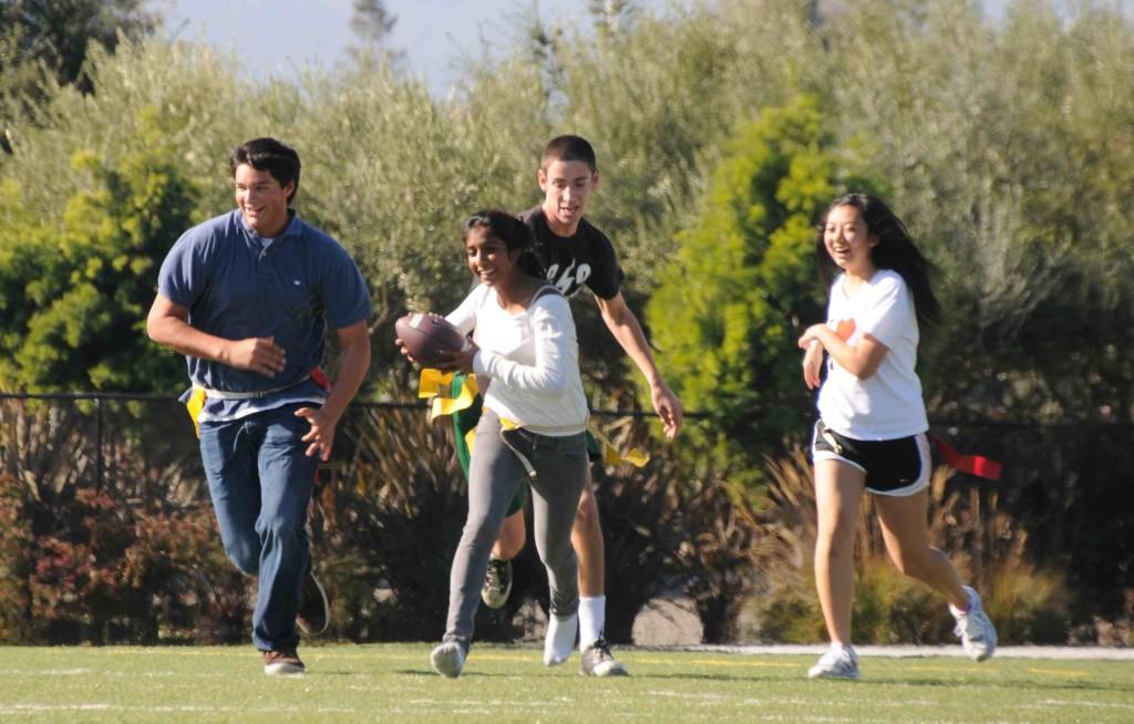 Ragini Bhattacharya (11) tries to score as Zachary Ellenberg (12) attempts to pull her flag. Fellow players John Patrick Doherty (11) and Apricot Tang (11) enjoy their time playing flag football during long lunch on Wednesday November 16 after a month long hiatus due to football season. 