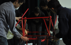 Engineering students participate in bridge-building assignment