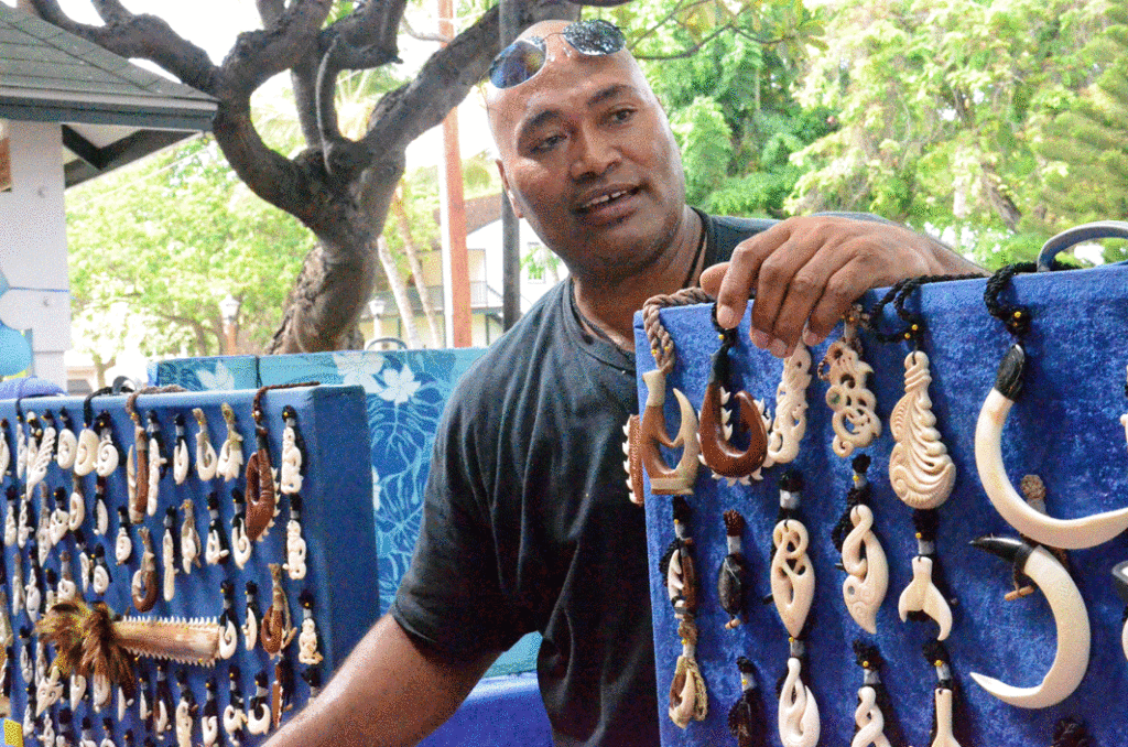 ‘One Tuai, a local artist, explains the legendary symbolism behind his wares. Located on Front Street of the Lahaina marketplace, his tables contain handmade goods ranging from traditional Hawaiian weapons to intricate hand-carved necklaces. Tuai has been carving professionally for over fifteen years and now works as part of the South Pacific Island Art group, which is based in Lahaina. 