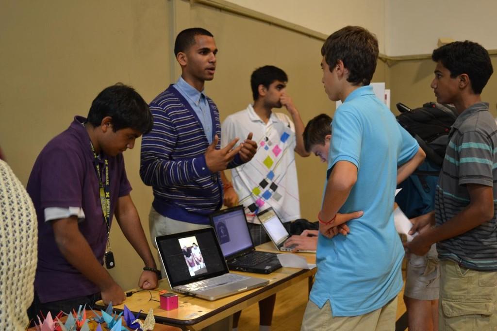 Nikhil Panu (12), co-president of Eagle Nation, explains the club's objective to newcomers. Members hope to boost school spirit by encouraging large groups of students to attend sporting events. The Fair allowed different clubs to promote themselves and recruit new members with interests parallel to the club's purpose.