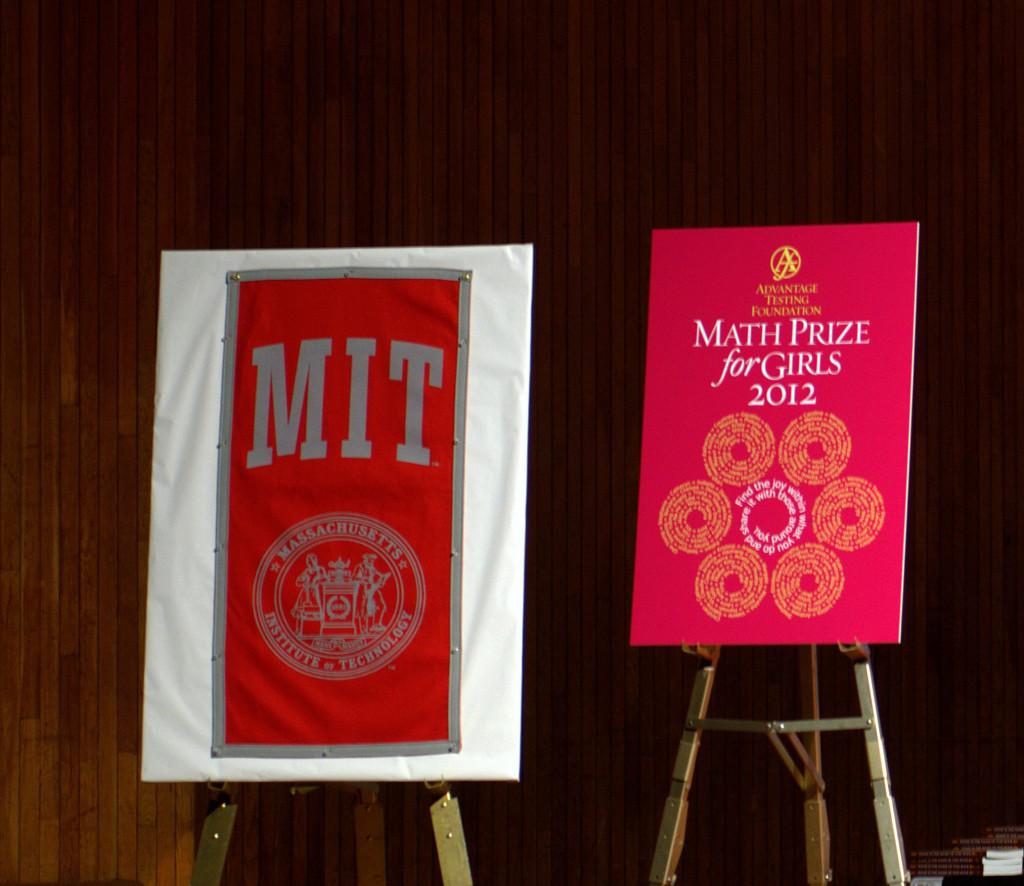 A+sign+with+the+Math+Prize+for+Girls+logo+along+with+an+MIT+banner+are+displayed+on+stage+during+the+competition.+The+contest+was+held+at+MIT%2C+and+many+MIT+professors+spoke+to+participants+during+the+awards+ceremony.