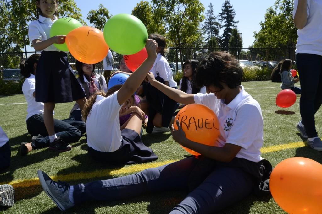 Shrreya Jain (12) plays with her Eagle Buddy during the balloon activity. In this event, students discussed the topics that were written on the colorful balloons. This helped them both bond and have fun with each other.