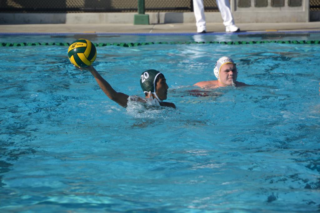 Michael Cheng (12) fakes the ball at the goal before passing it to a fellow player.  The team used the second half to fine tune skills such as faking as they already had a 8-1 lead. 
