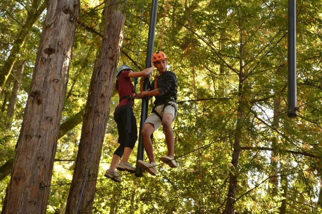 Vishal Vaidya (10) and Erika Olsen (10) work together to cross one of the obstacles that was a part of the ropes course. In order to succeed, they had to use spread out black tubes and each other to balance while walking across a thin wire.