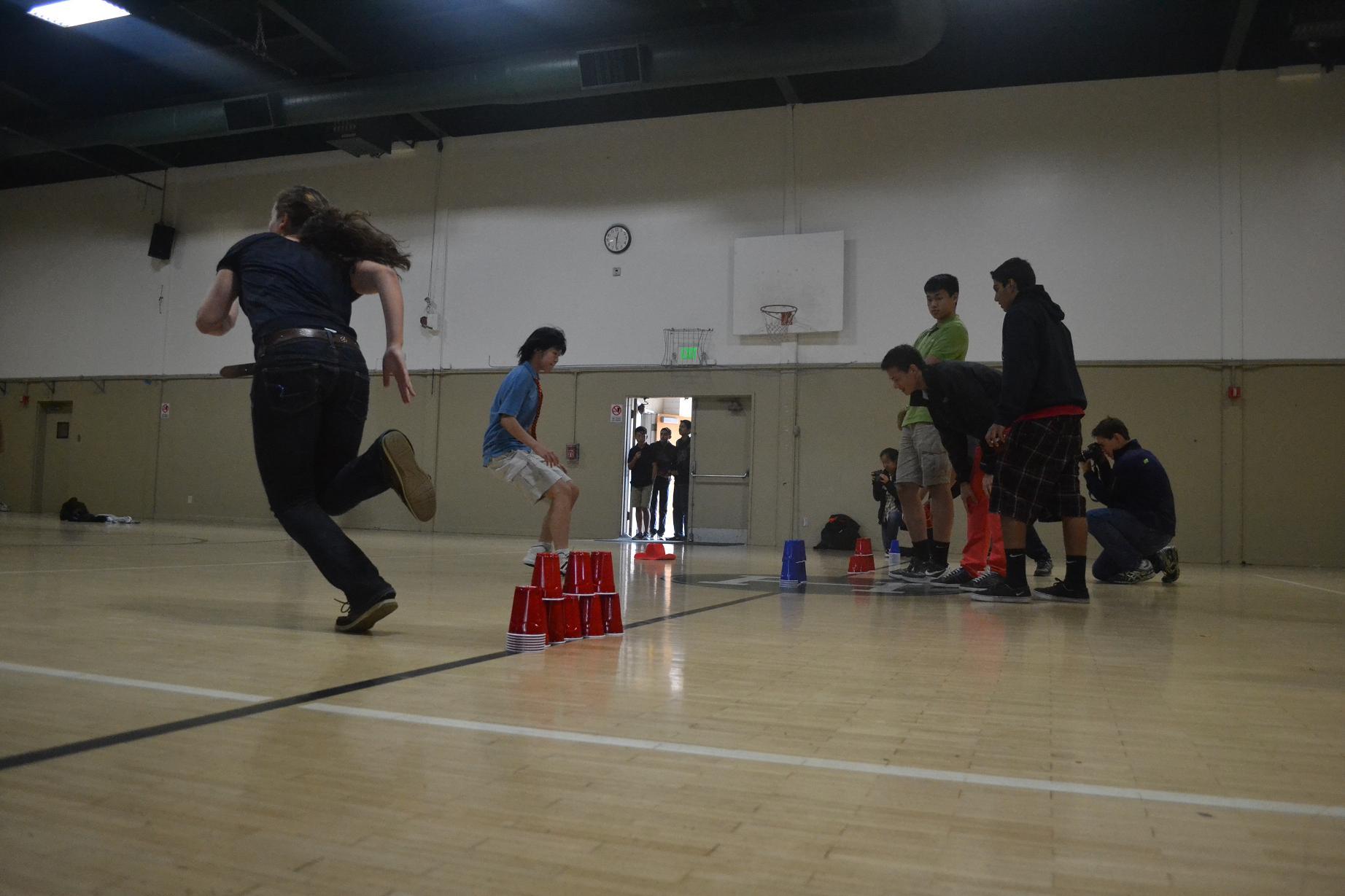 Monika Lee (11) races toward the junior class pyramid in the sixth lunch round of the event as a senior races back to her teammates on the other side of the gym. The junior class ended up winning that round.