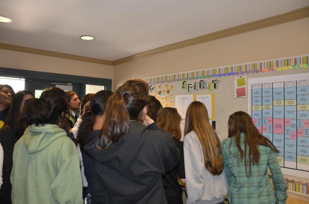 Students crowd around the Spirit Board to see which members of their class were nominated for homecoming court. 
