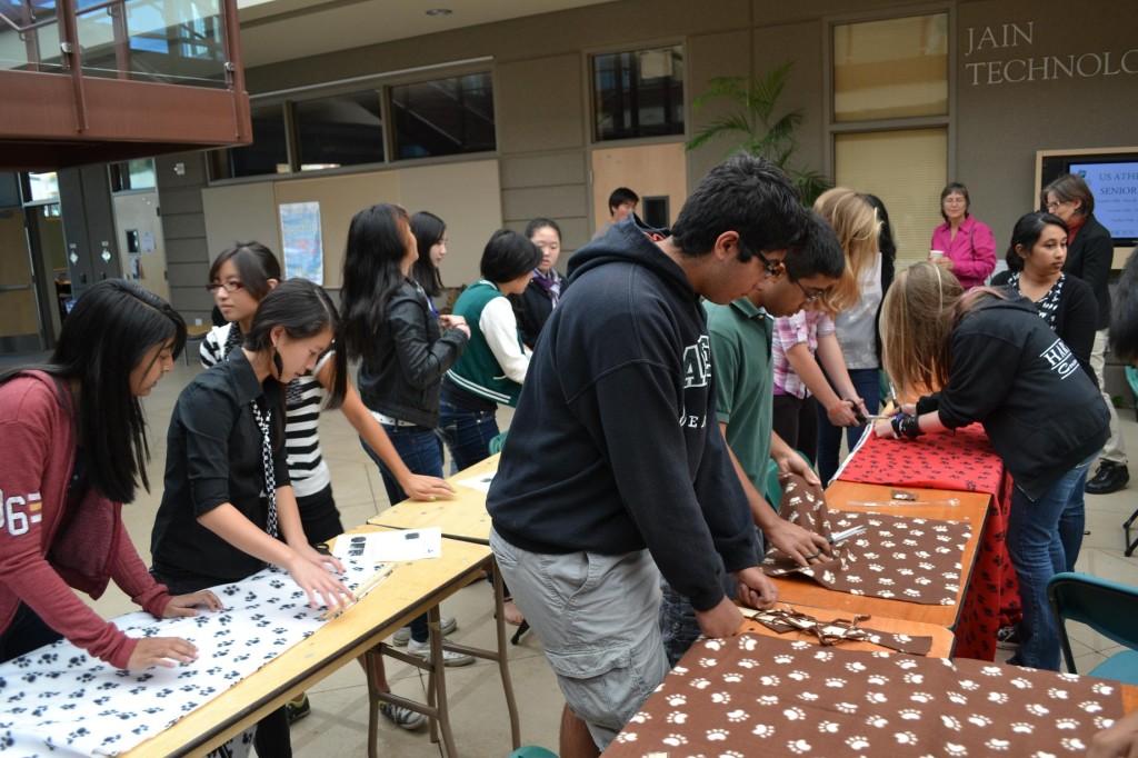 Key Club and Interact Club members work together to make toys and blankets for dogs at the local animal shelter. After every meeting, club members participate in a short project to help the community and encourage attendance.
