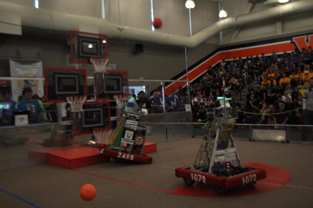 Kinematix, the teams robot (right), shoots a ball at the hoops. The Upper School robotics team competed in the Calgames Robotics Tournament on Saturday, October 13.