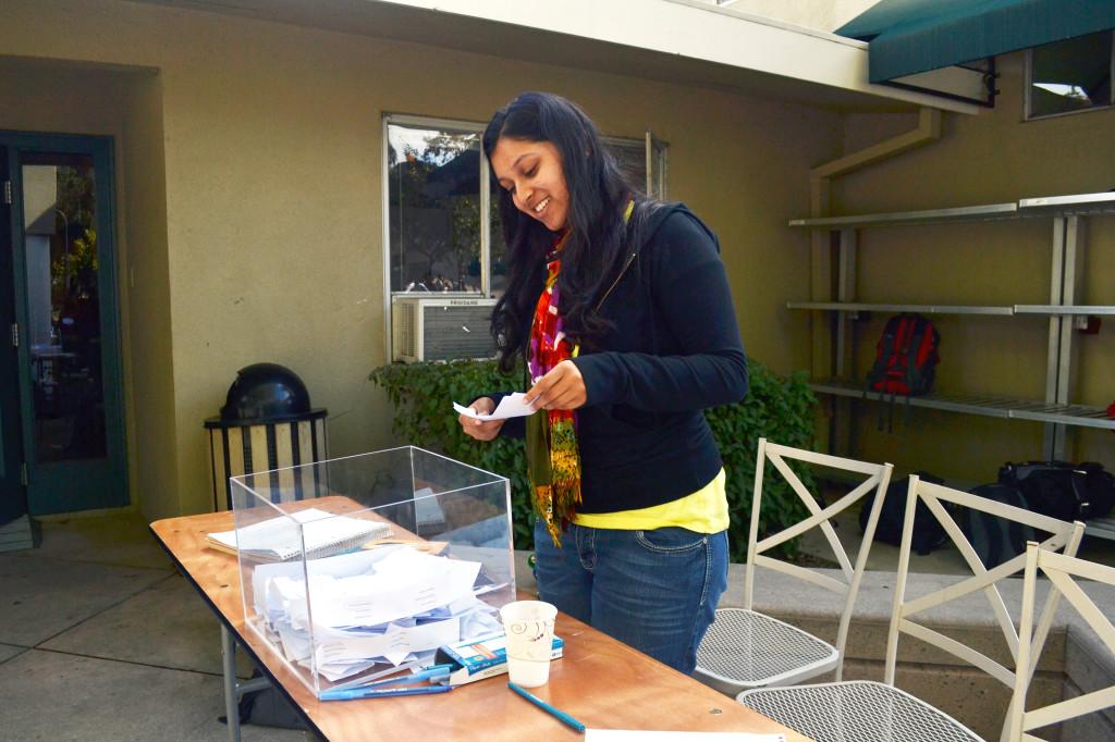 Spirit Club member Indu Seeni (12) runs the voting for Homecoming Queen and King in front of the Edge. Results will be announced at the Homecoming Game.