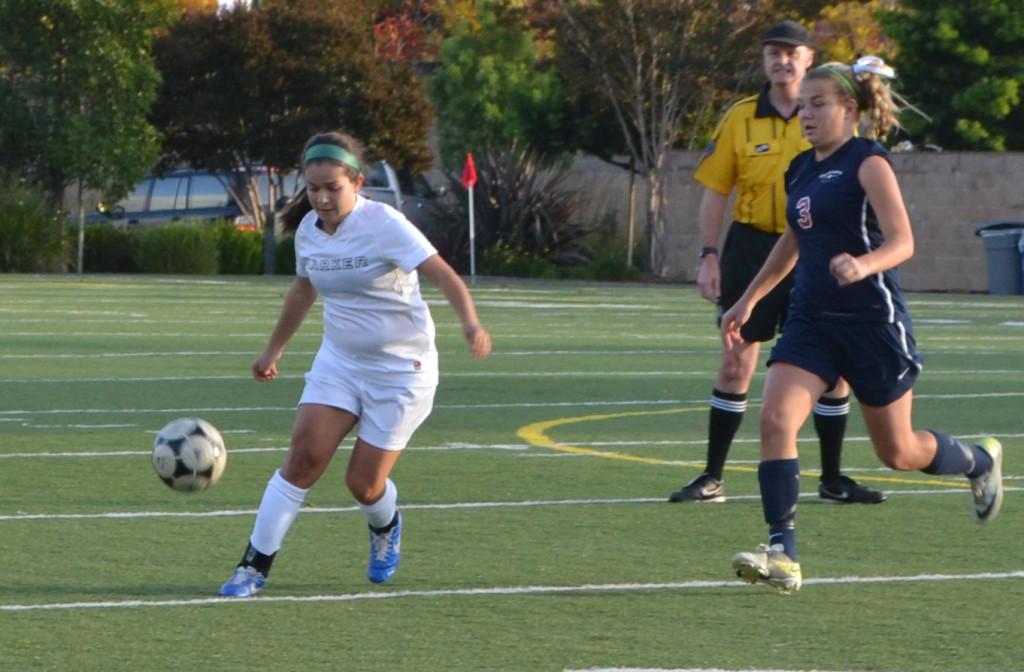 Senior Sondra Costa dribbles the ball as an opponent approaches to her left. The Varsity team played aggressively throughout the game to open more opportunities for the Eagles to score.