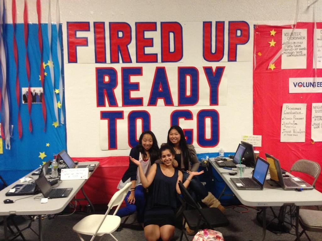 Freshmen Ashi Gautam, Jasmine Liu, and Shannon Hong take a break from making calls to ask citizens to vote for President Obama. The wall featured a slogan, Fired Up and Ready To Go, which the volunteers shouted before the election results came out. 