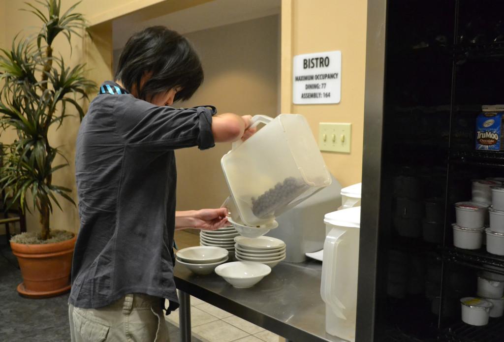 Junior Monika Lee pours some cereal to add to her breakfast. Common breakfast foods such as toast, cereal, and bagels were available for students to enjoy.