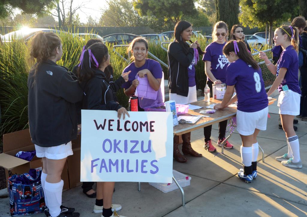 During the boys soccer game, the girls sell merchandise to spectators. Items included cupcakes and T-shirts, which were the tickets to the game. The players welcomed families from Camp Okizu with open arms, flaunting a poster to show their support.