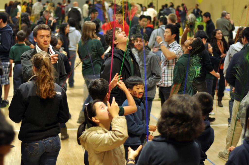 Students attempt to balance peacock feathers on their faces as part of one of the activities during the Eagle Buddies event. The fourth grade students visited the Saratoga campus today to meet with their junior Eagle Buddies.