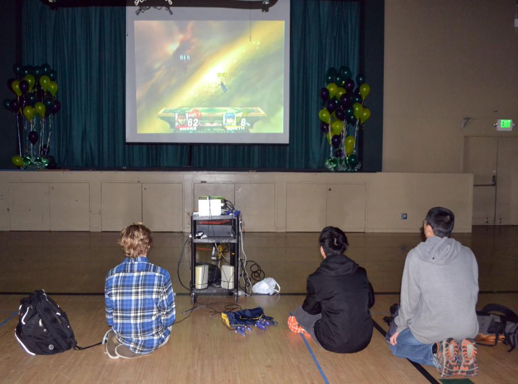 Students gather around a Wii game console as a part of the STEM lunch event hosted by IGL and Programming club. Led by WiSTEM, the Science, Technology, Engineering and Mathematics clubs on campus are collaborating to "Save the World" with STEM week by raising money for various causes.