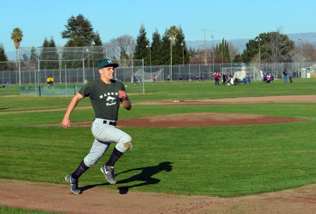 Senior Kevin Cali sprints to first base at practice on Wednesday. The team will play its first game next Thursday.