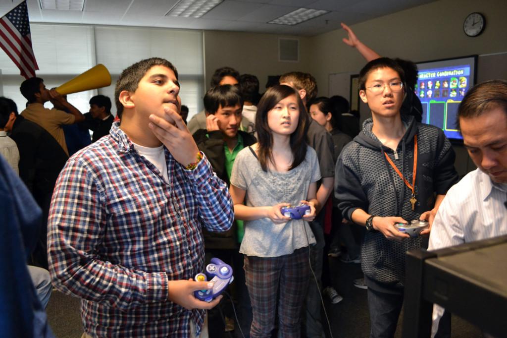 Ajay Chitkara (10), Victoria Lin (12), and Raymond Cheng (11) focus intently on the TV screen while playing Mario Kart: Double Dash. IGL members set up two stations in order to speed up the tournament process. Even though only three people could win prizes, most still had fun participating.