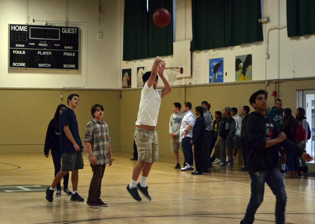 Freshman Edwards Sheu shoots a basket as the other members of the freshman team look on. The Key Club basketball tournament took place during long lunch on Wednesday, March 6.