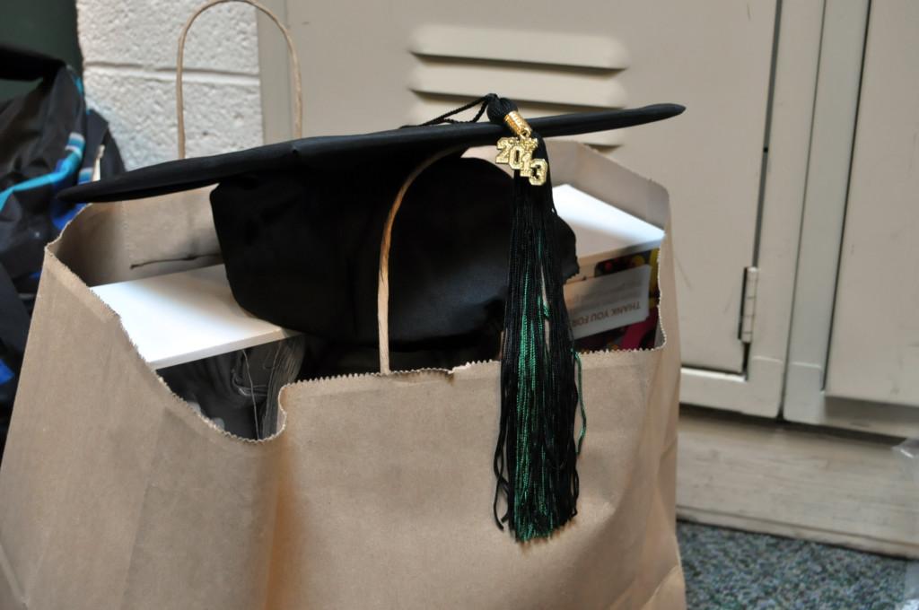 A graduation cap with its tassel lies on top of a bag. Seniors received and tried on their caps and gowns during a class meeting on Wednesday.