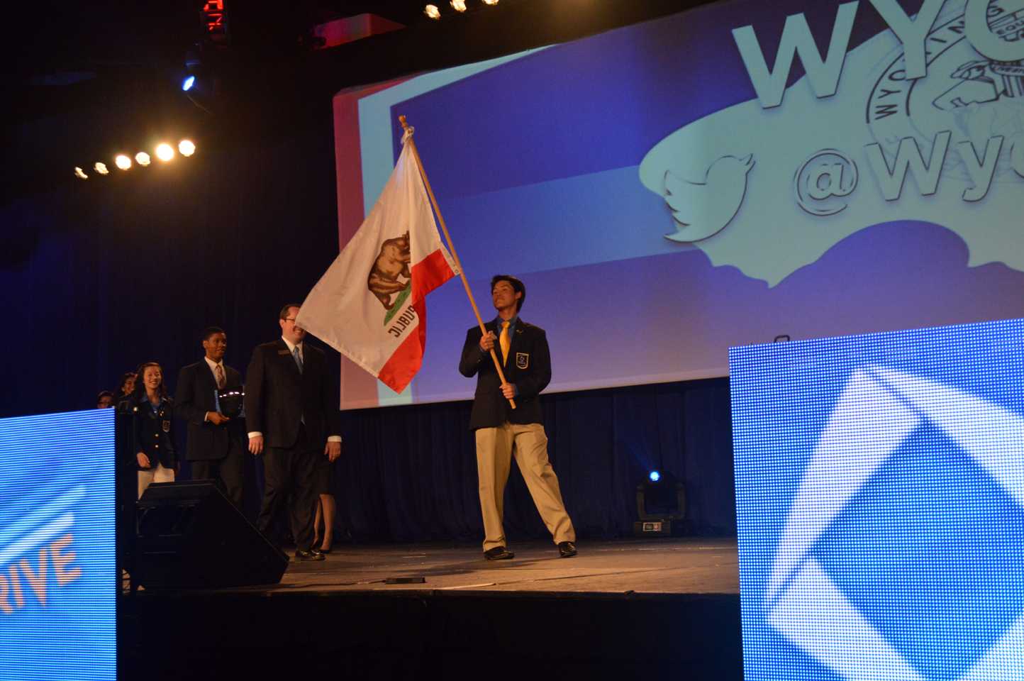 Members of California DECA walk across the stage during the ICDC opening ceremony. Eighteen Upper School students attended ICDC to participate in business competitions and leadership programs.