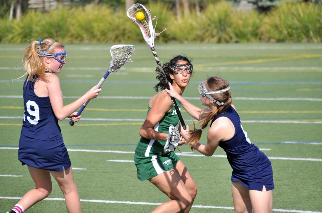 Senior Tara Rezvani attempts to steal the ball from Mercy Burlingame. The girls lacrosse team defeated its opponent 17-7 on Thursday, April 11.