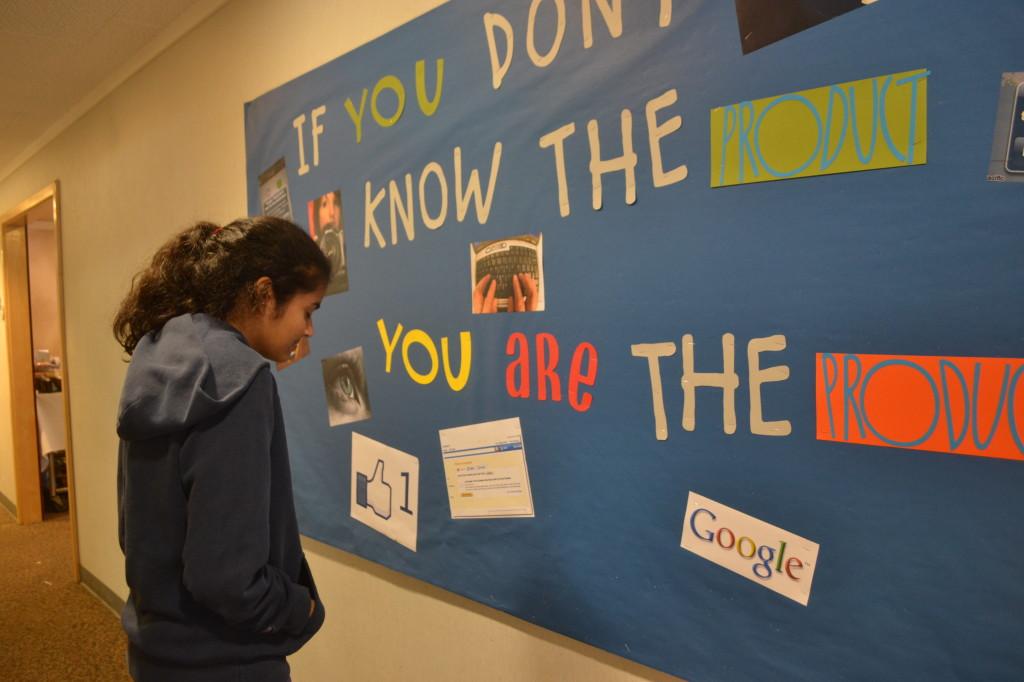 Sophomore Archana Podury stops by the Choose Privacy Week bulletin board to read some of the information posted. The bulletin highlighted the central message, If you dont know the product, you are the product, which was surrounded by images representing privacys role in everyday life as well as the invasion of privacy.
