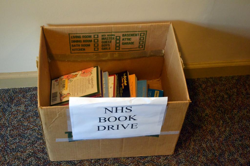 Boxes for the National Honor Society (NHS) book drive donations are stationed around campus. NHS decided to hold this drive to provide other students outside of school with educational resources.