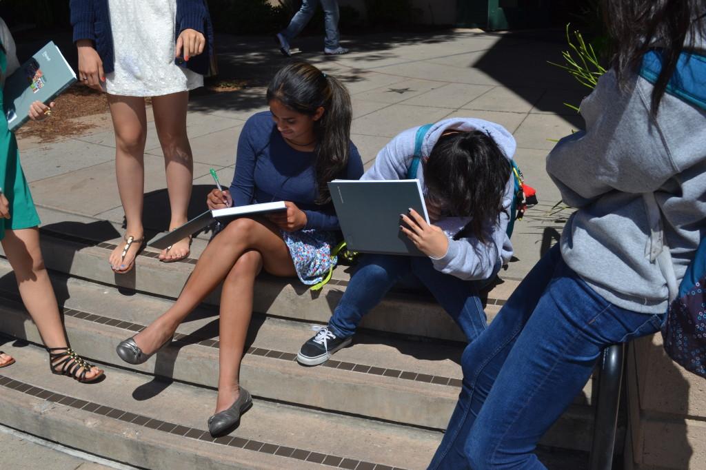 Freshmen Sai Sunkara and Panny Shan sit atop the stairs leading to Dobbins Hall, signing friends’ yearbooks. Yearbook signatures are a great way to keep in touch with friends and remember the good times shared with them in high school. 