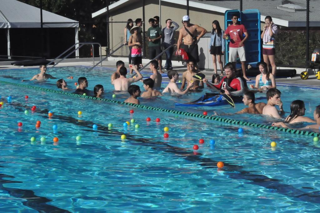 Rowing in his kayak, Mr. Irvine rallies the students playing games in the pool at the annual Gym Jam. Students met to brainstorm spirit ideas for the upcoming year.  