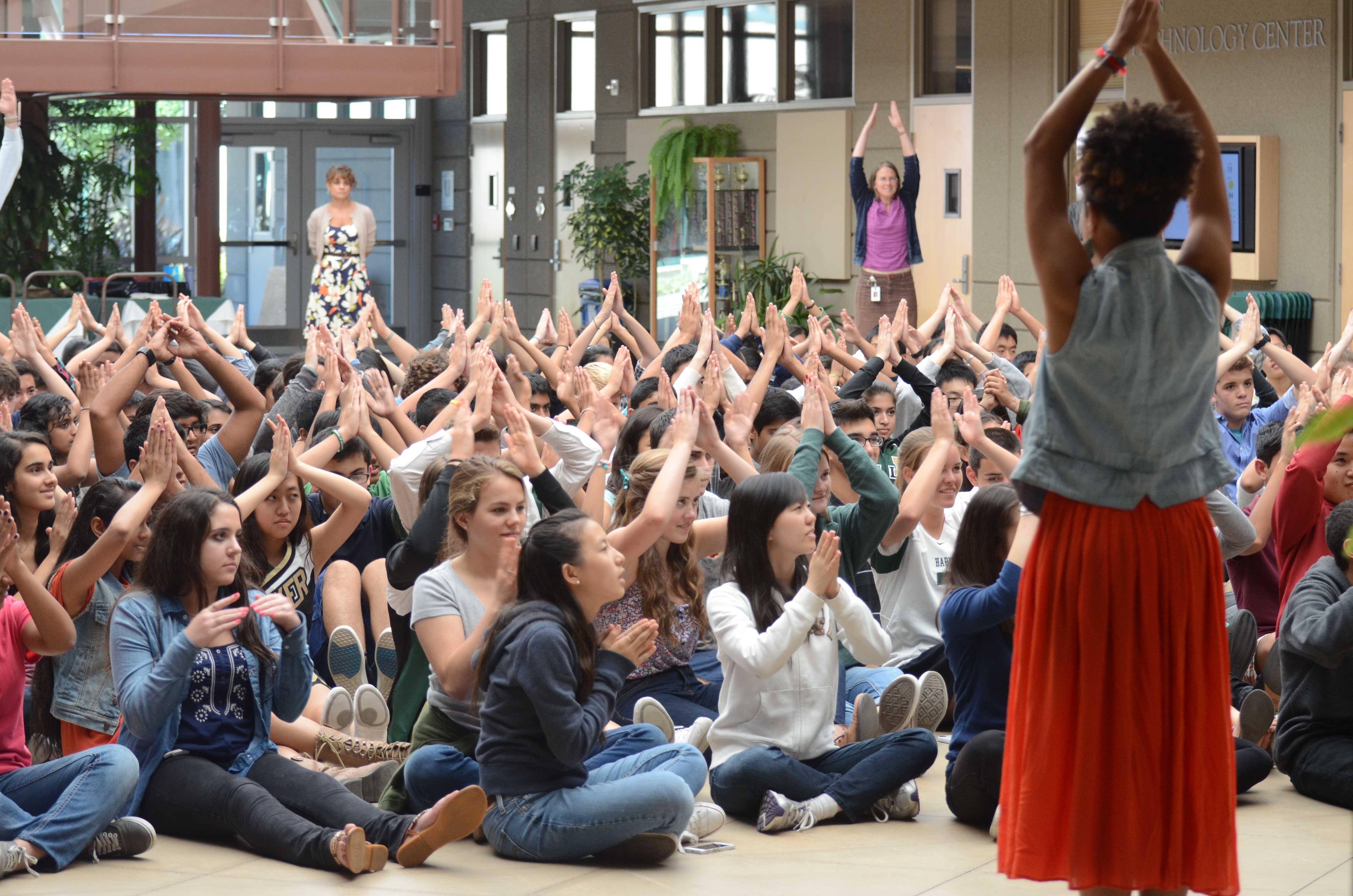 Members of the junior class raise their arms in the shape of a tree during a game in their Thursday LIFE session. The representatives from Youth Empowerment Seminar used this game to make students focus.