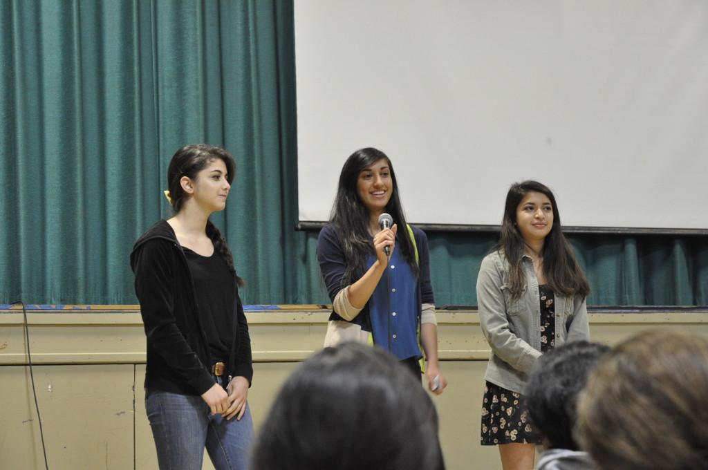 Juniors Mariam Sulakian, Avni Barman, and Riya Godbole announce the Halloween costume drive at school meeting this morning. The drive is collecting costumes for children of all ages and will continue through the beginning of next week.  