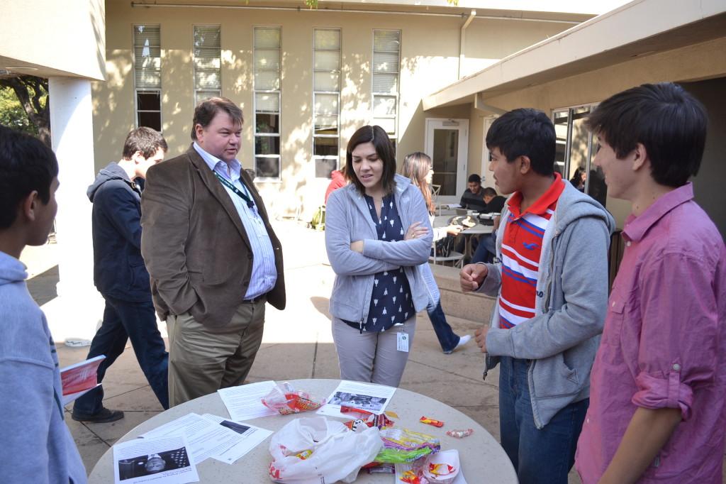 Communication Studies teacher Greg Achten stops by the speed reading table outside of Manzanita. The spread-off encouraged students to try their hand at reading papers provided as fast as possible while still enunciating.