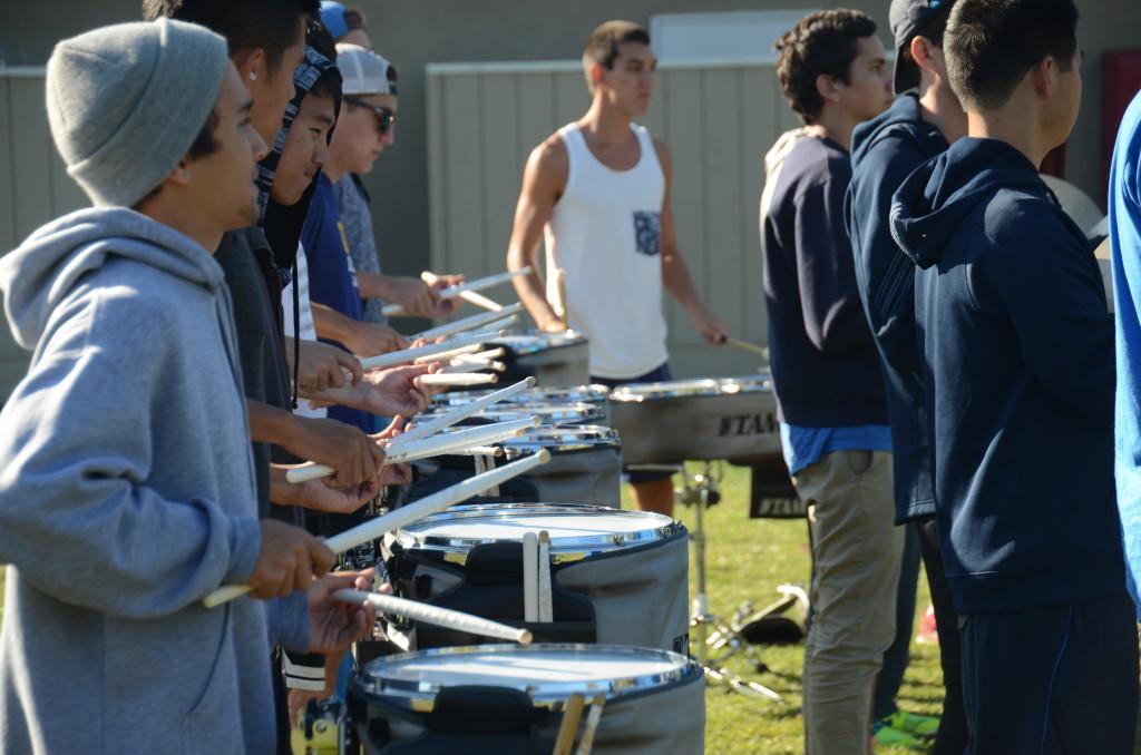 The UCLA drum line practices on Rosenthal Field prior to UCLA's football game against Stanford. Students watched the band practice during extra help and class.