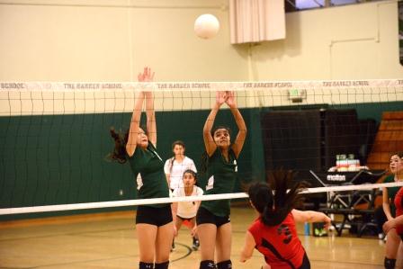 Lindsey Trinh (9) and Ankita Uppugunduri (9) jump up to block a hit from Mercy SF’s player. Ankita played middle front while Lindsey played right side. 