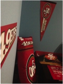 Inside the room of a 49er fanatic, the walls are covered with all red and gold to show support and spirit. 