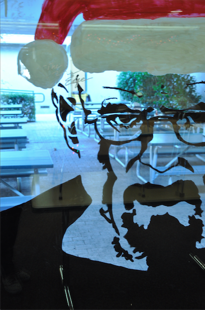 Walter White, the main character from the popular but no longer airing show Breaking Bad, stares at passersby. Cheryl Liu (11) freehanded the face with Expo marker while other juniors painted in the outlines from the other side of the glass. 