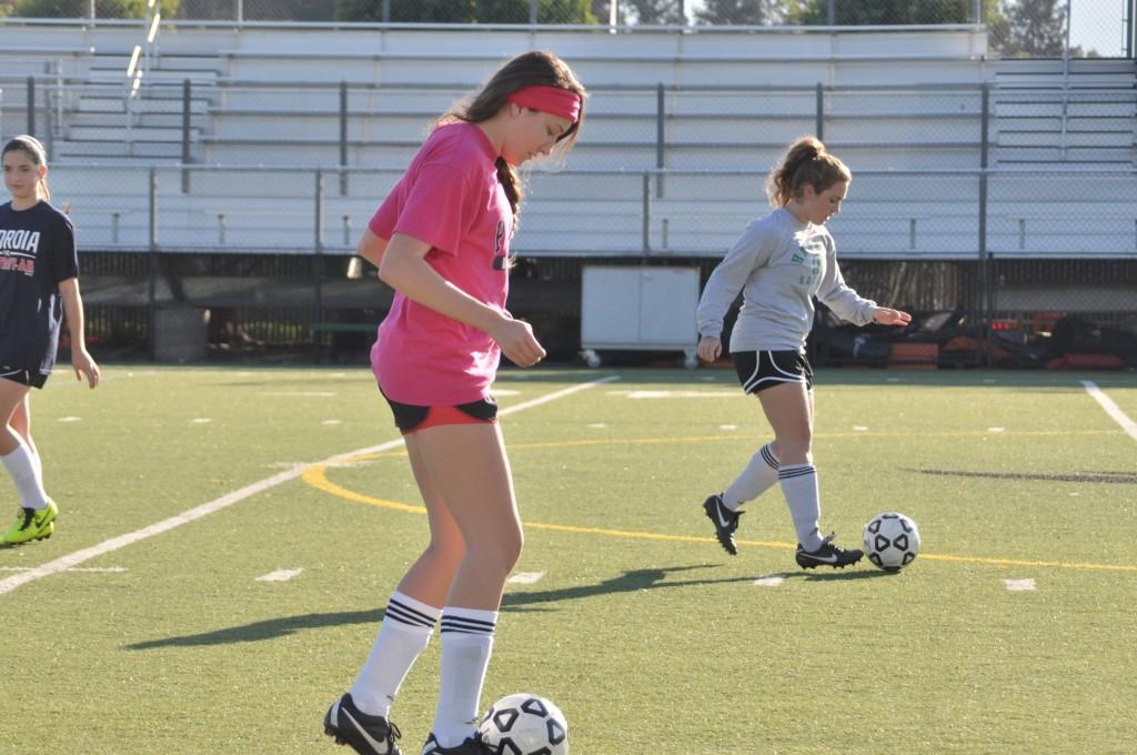 Varsity girls soccer players Taylor Mahal (12) and Camille Piazza (12) began their tryouts with basic dribbling drills. Players also participated in small-sided games and transition exercises in order to demonstrate their skills to the coaches. 
