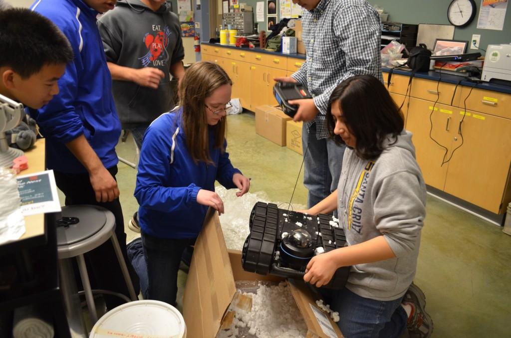 The Robotics team unpackages the Avatar I Micro tactical robot, which was donated by tech company RoboteX. The machine will be demonstrated at the STEM Fair and local robotics competitions. 

