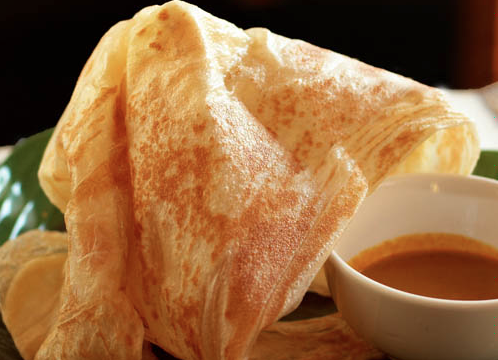 Roti canai is one of Layang Layangs most popular dishes. This flatbread is served with a side of tasty curry.