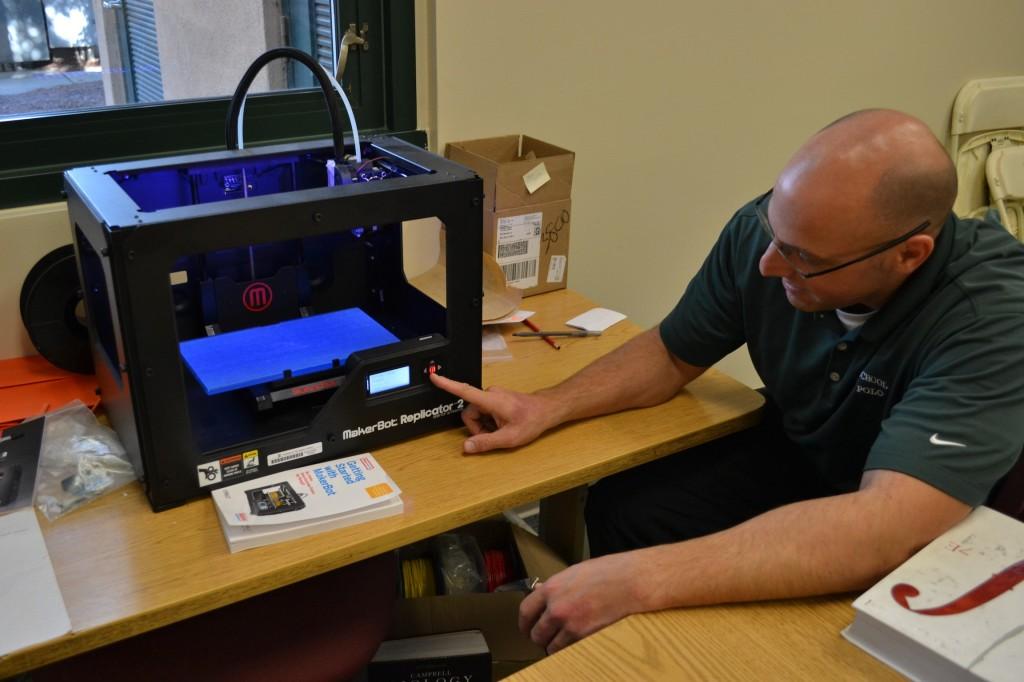 Math teacher Victor Adler demonstrates the 3D printer located in his room. He has used this gadget in his classes to demonstrate 3D modeling.