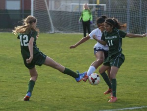 Joelle Anderson (9) and Nikita Parulkar (11) work together to keep the ball away from their opponent. The girls' lost their league playoff game against Kings Academy 2-1.