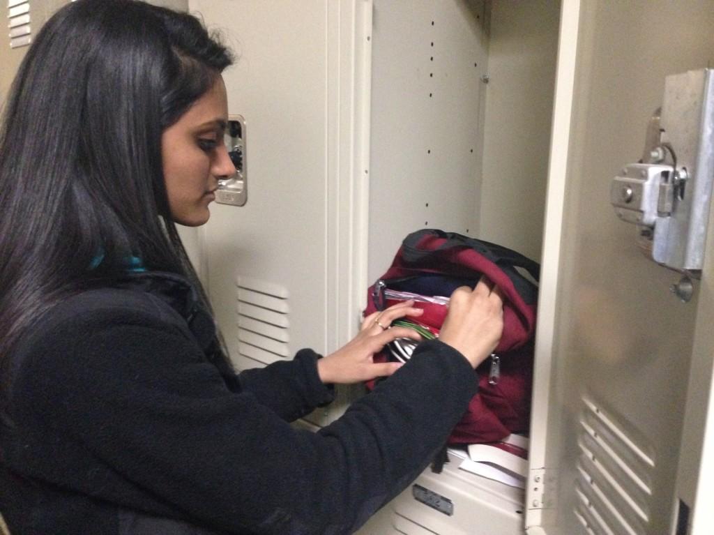 Pooja Chirala (12) uses her locker throughout the day to lighten the weight of her backpack by exchanging books and binders. 