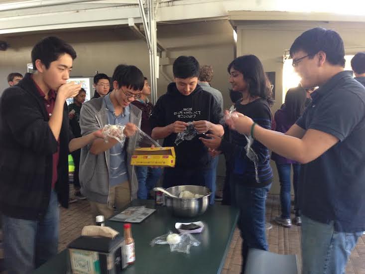 The Japanese National Honor Society helps students make rice balls during lunch as todays feature Japan Week activity.
