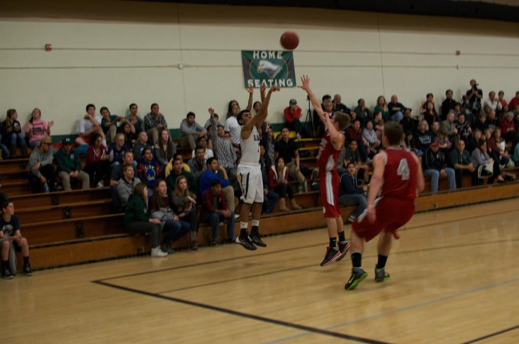 Srivinay Irrinki (11) shoots a three-pointer in the game against Carmel High School. The team won 46-40. 