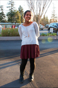 Gabi flaunts her unique sense of style in a simple white sweater and maroon skirt.