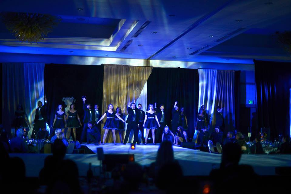 Downbeat performs We Own the Night with Middle School students at Night on the Town, Harkers 11th annual gala. The gala featured eight musical numbers and two video simulations of a gym and theater complex, the schools current capital project.