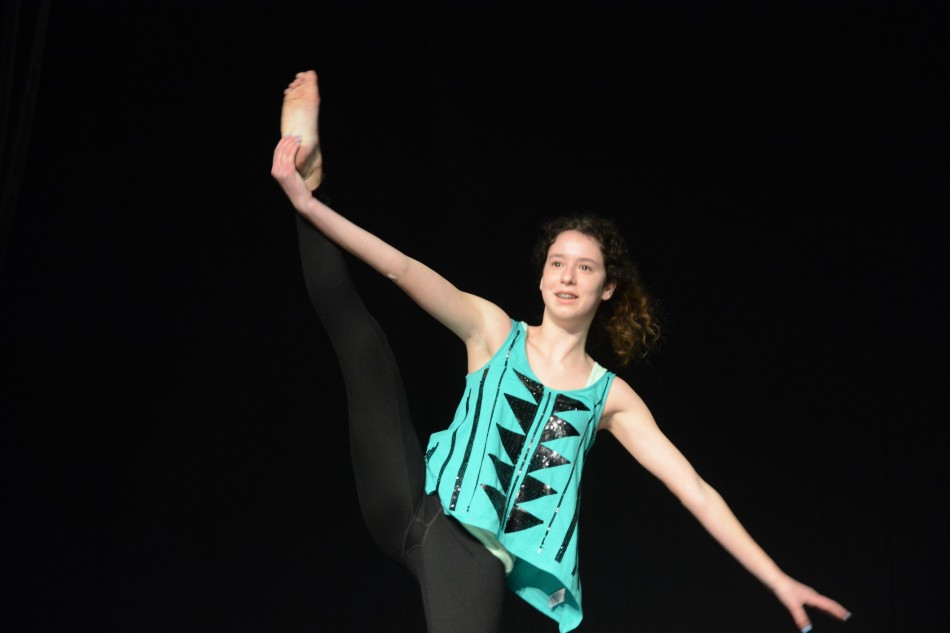 Noa Sasson (9) does a vertical split during her poi performance. Her act won the award for Best Solo Performance.