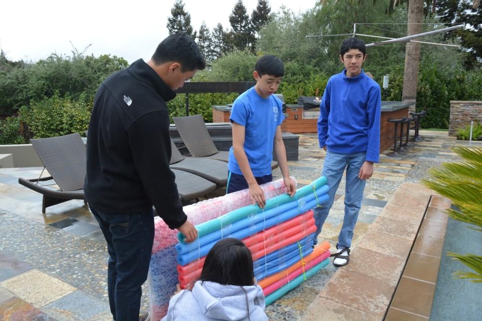 Float or Sink: The freshman class works on building their raft. Spirit week starts April 14; events include dress-up days and daily class competitions.